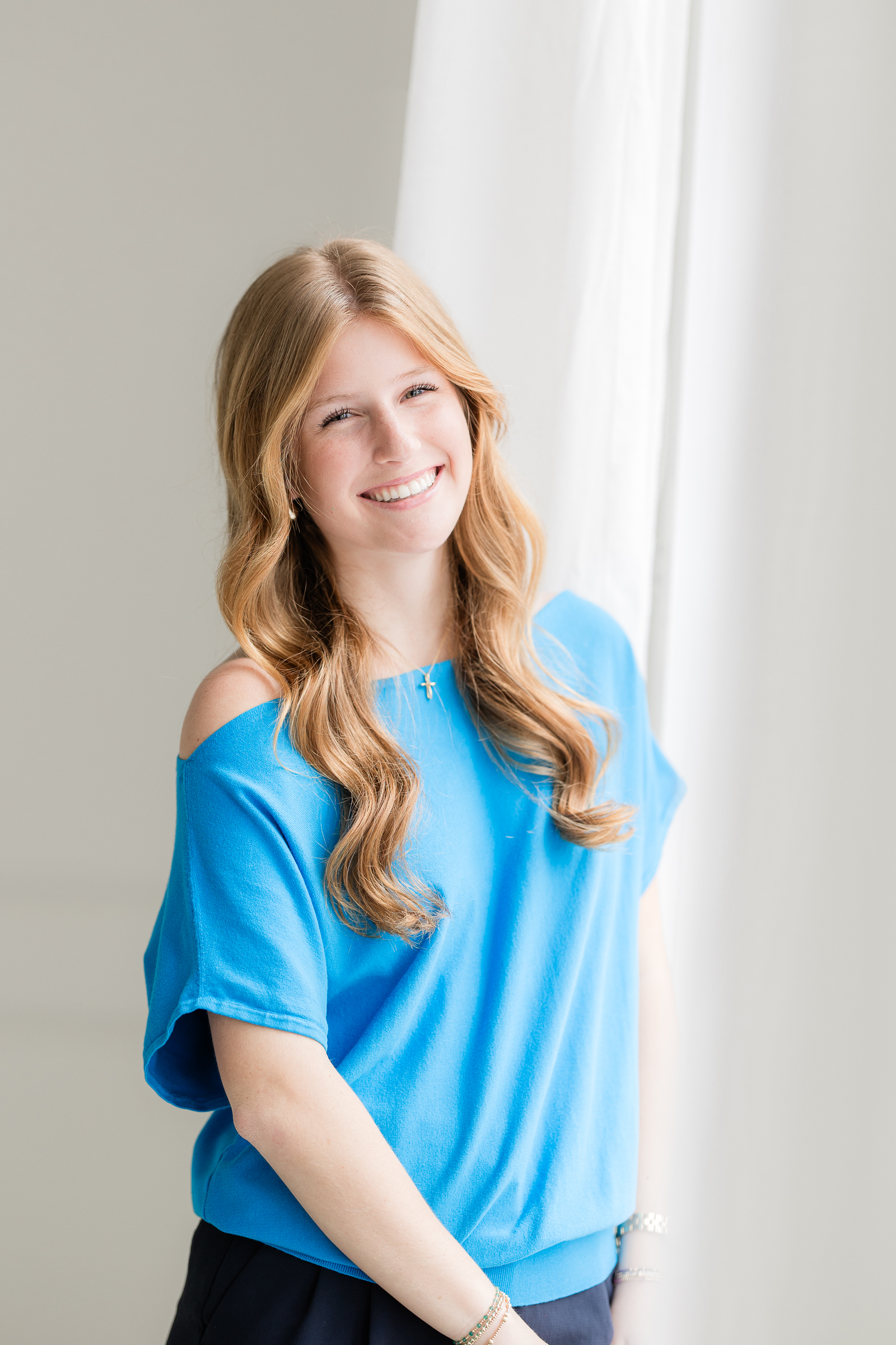 bright headshot smiling naturally to reflect personality and professionalism