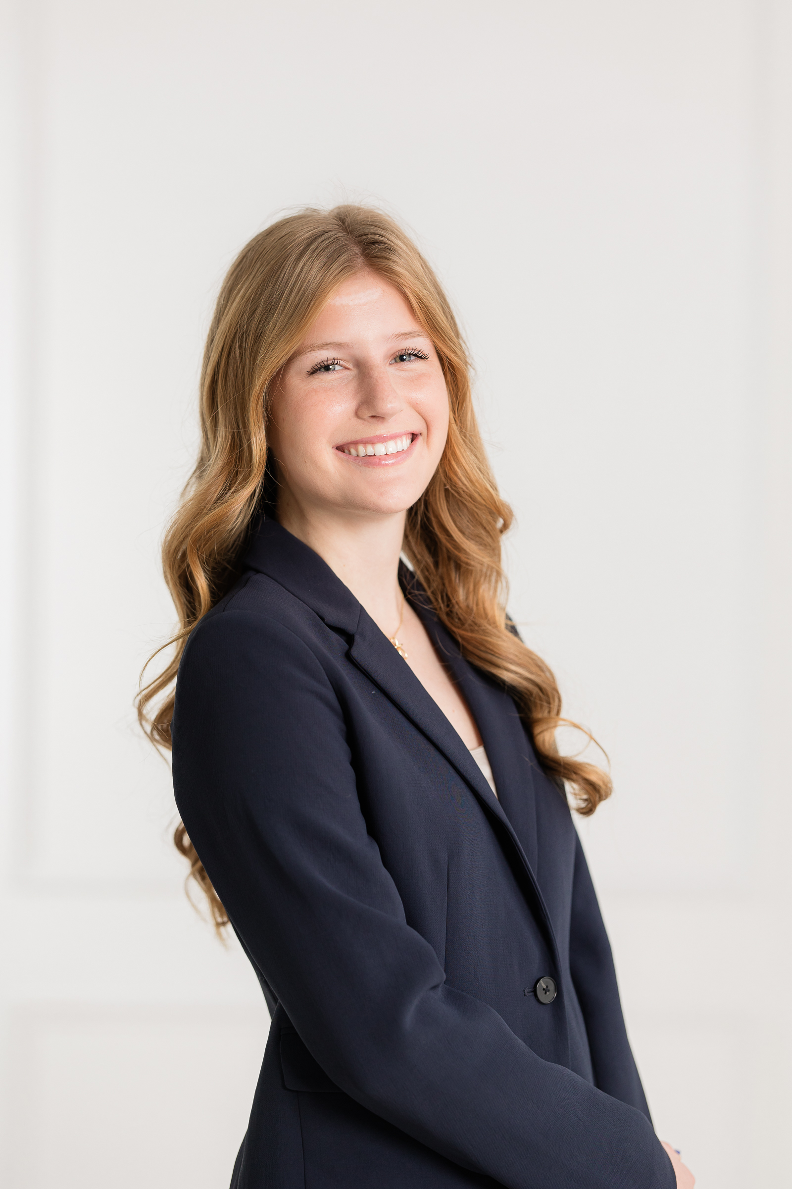 polished branding photo in a navy blazer that shows professionalism without feeling corporate