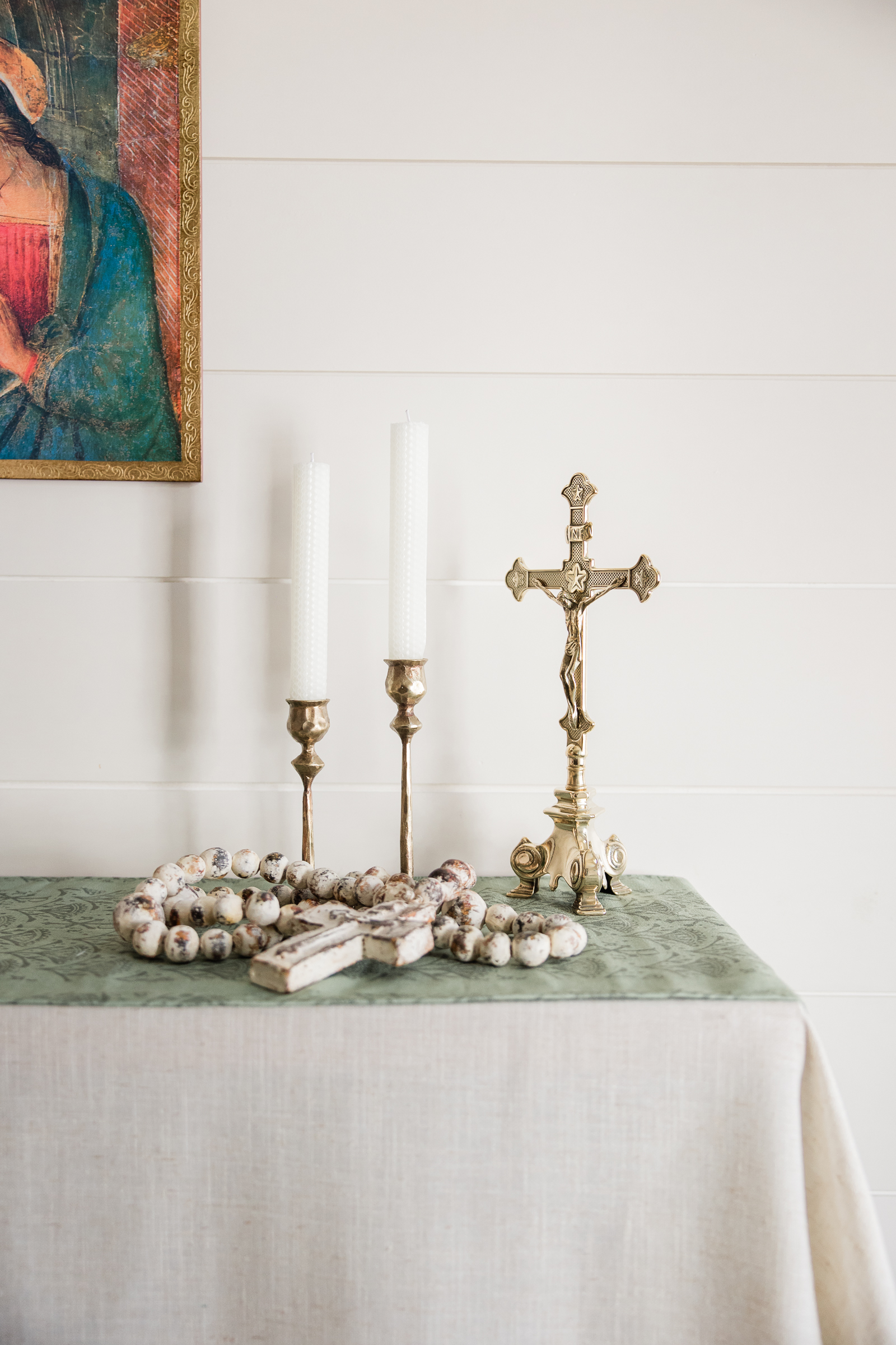 Rosary beads, crucifix, and Catholic devotional items arranged for faith based product photography.