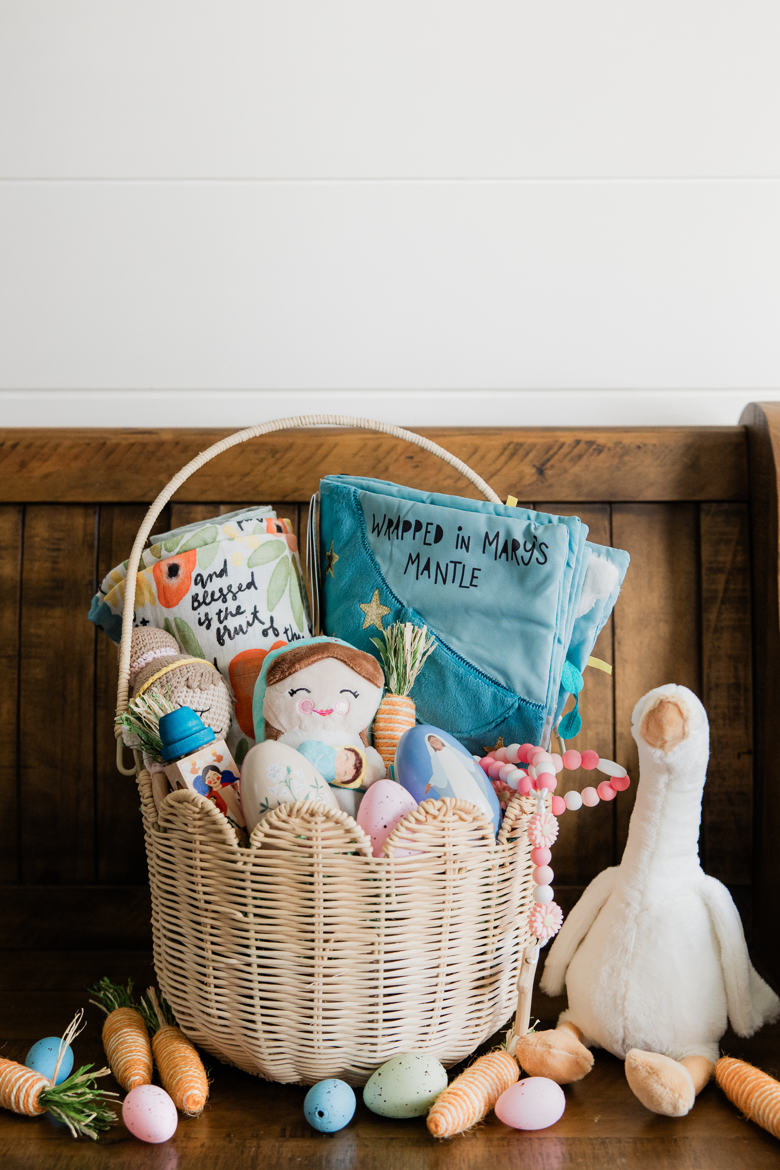 Catholic Easter basket with faith based toys, rosary bracelet, and devotional items styled for product photography.