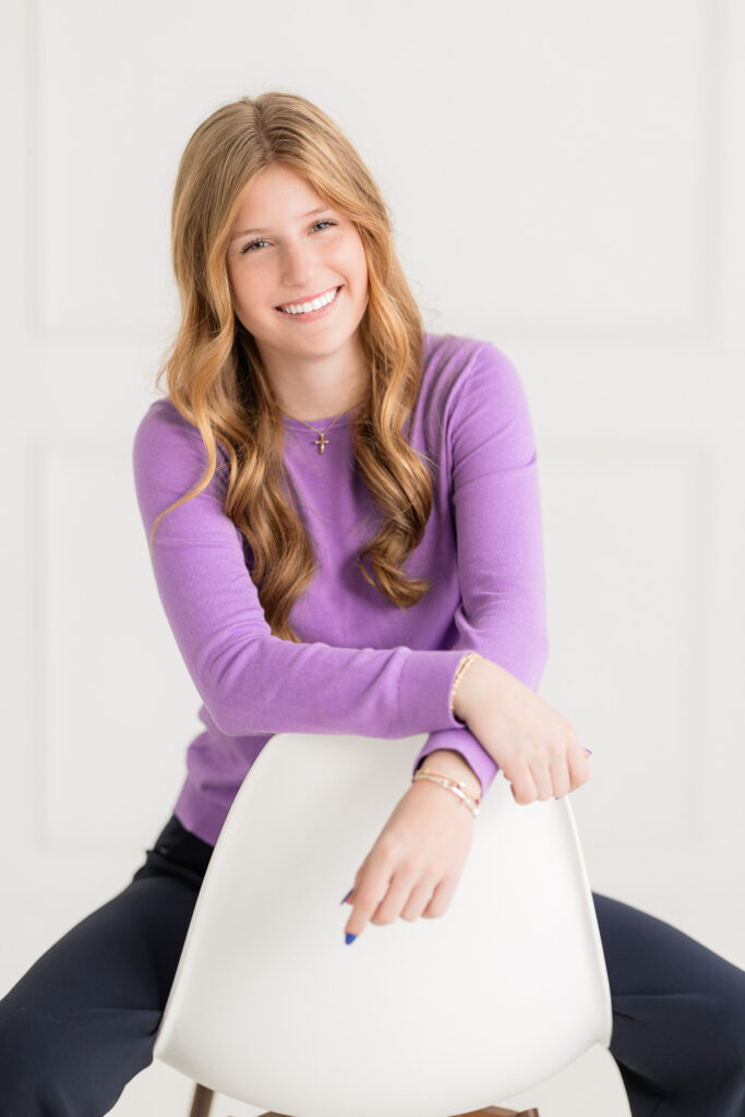 a woman wearing a purple shirt in a professional image