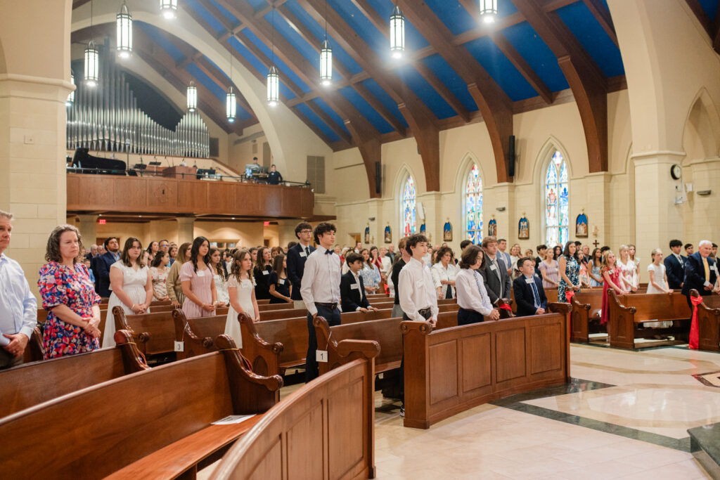 A bishop blessing a confirmation candidate at the altar, captured by a Catholic photographer