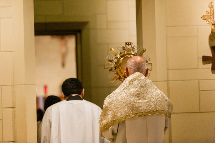 A priest in golden vestments celebrating Mass, photographed by a Catholic photographer